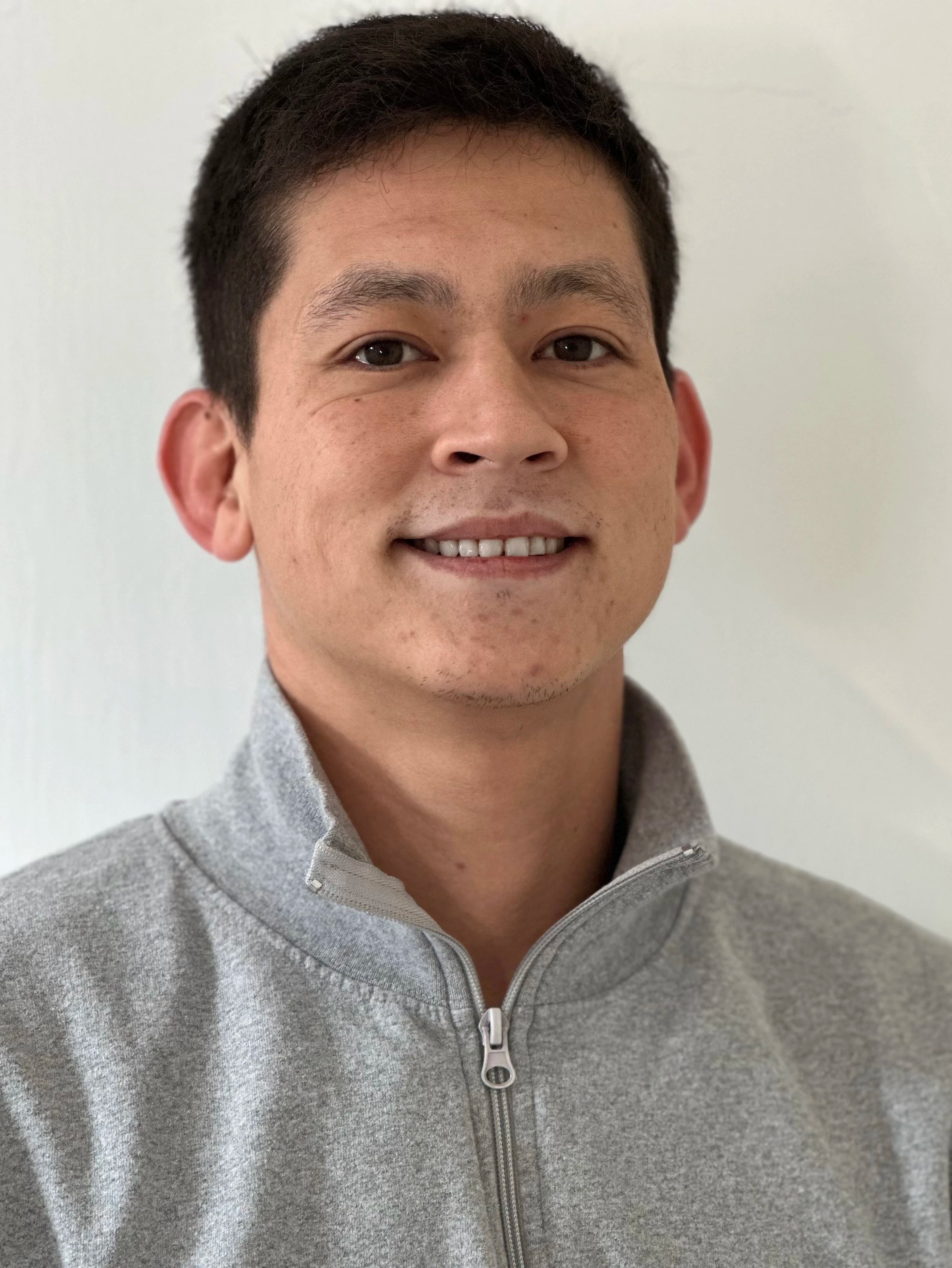 Will Schweizer EMS Trainer at  Body Reset Montecito headshot wearing a gray zip-up sweater against a plain background